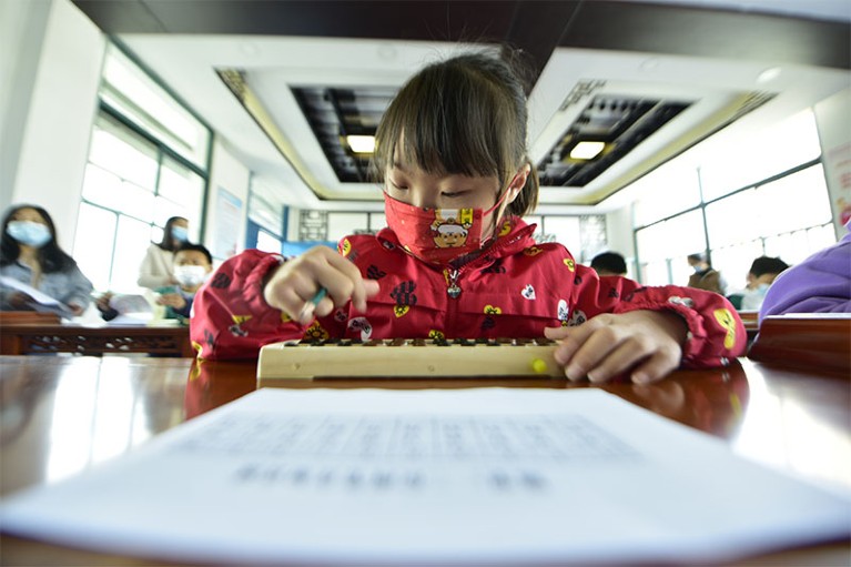 A child uses an abacus in a primary school in Hefei, Anhui province, China.