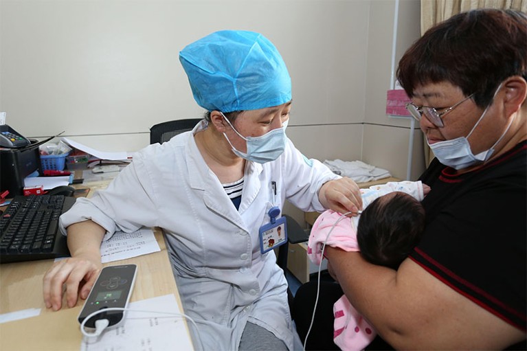 A doctor performs a hearing test for a baby in Shaoxing, Zhejiang province, China