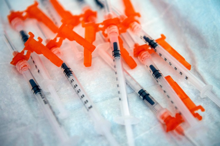 Syringes containing the Moderna Covid-19 vaccination sit on a paper-covered tray