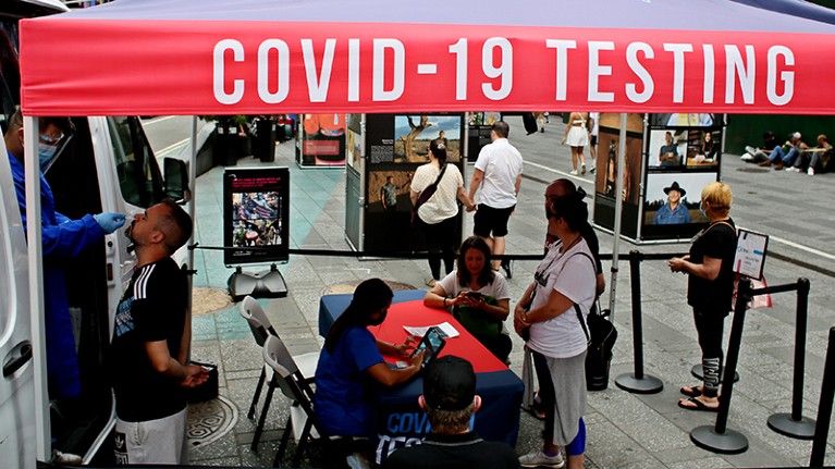 A man is tested at a COVID-19 testing van as persons wait in line in New York City, U.S. on June 06, 2022.