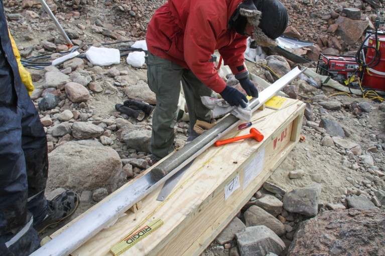 A researcher examines an extracted ice core from the Ong valley in Antarctica
