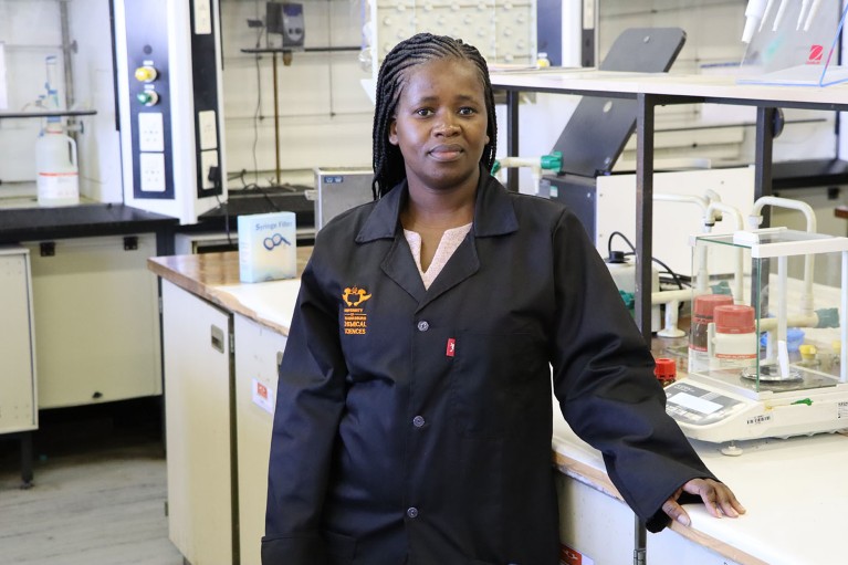 Philiswa Nomngongo stands in front of a lab bench