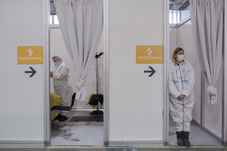 Two medical workers in PPE await patients to receive a dose of the anti-Covid-19 vaccine on March 20, 2021 in Belgrade, Serbia.