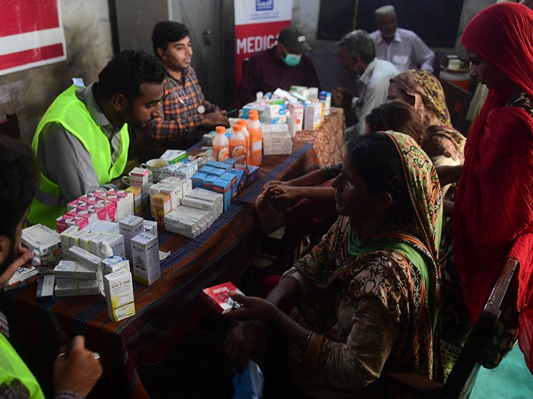 People receive medicines at a free medical camp run by Al-Khidmat Foundation for flood affected people, Pakistan.