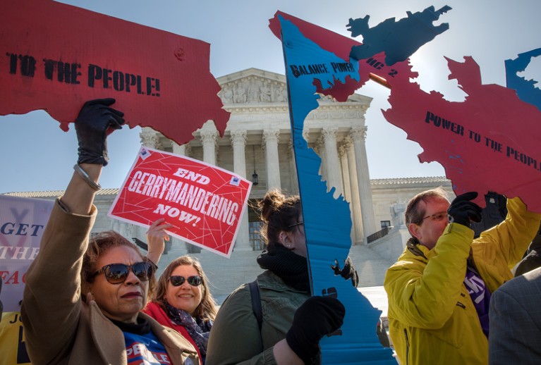 People protest gerrymandering with placards in the shape of voting districts at a demonstration outside the US Supreme Court