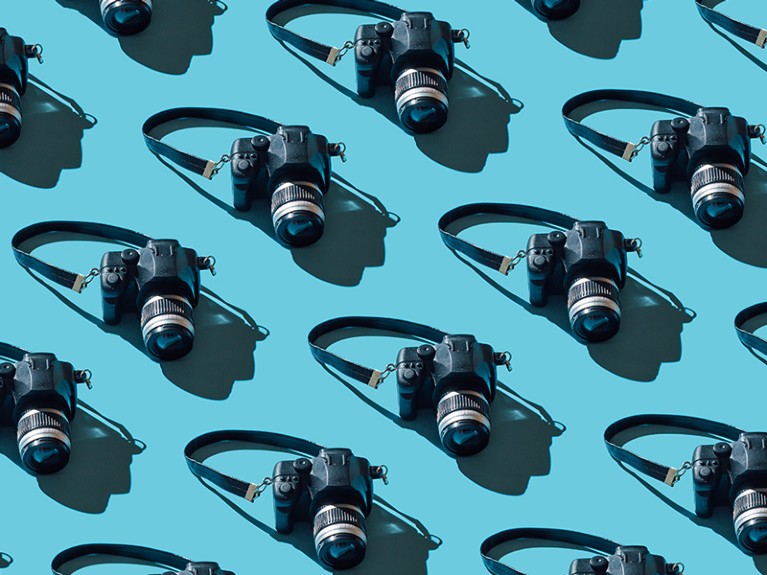 Pattern of cameras on blue background.
