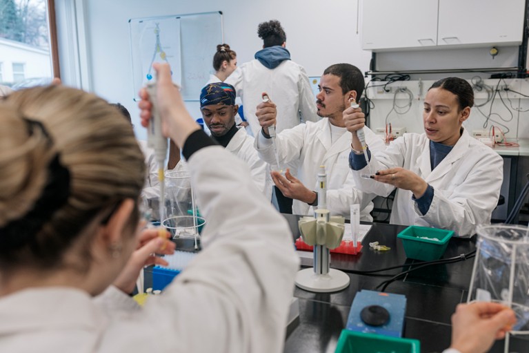 A group of medical students working together on a practical experiment in a laboratory