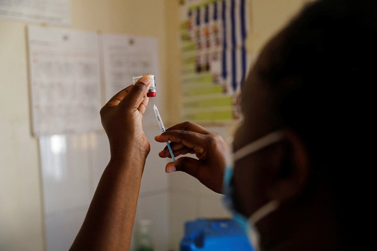 A nurse fills a syringe with malaria vaccine for an infant at the Lumumba Sub-County hospital in Kisumu, Kenya, July 1, 2022.