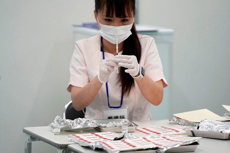 A nurse checks doses of the booster Moderna COVID-19 vaccine at a vaccination center in the complex of the Tokyo Skytree, Japan.