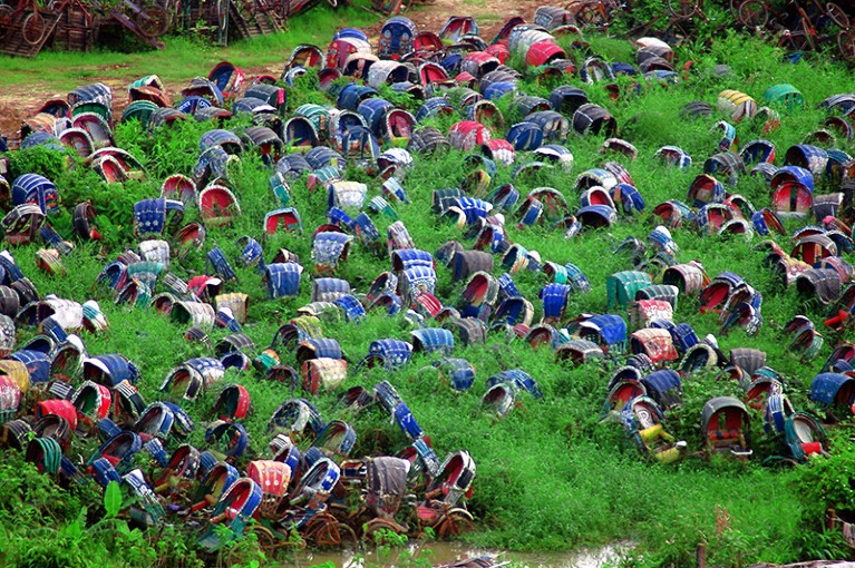 The police dump rickshaws confiscated from rickshaw pullers who violate the law or are unlicensed in Dhaka, Bangladesh.