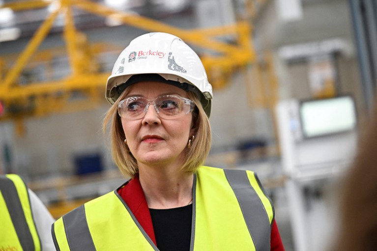UK Prime Minister Liz Truss wearing a high visibility jacket, safety googles and a hard hat during a tour of a factory
