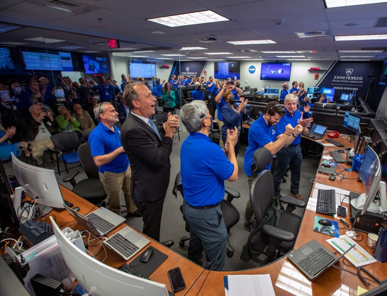 The DART team applaud and celebrate as they receive confirmation of a successful collision