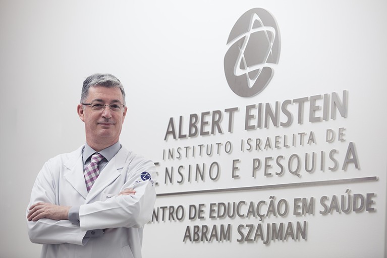 Luiz Vicente Rizzo standing in front of hospital sign