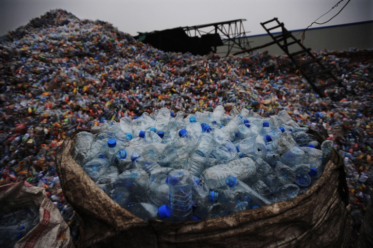 Huge piles of used plastic bottles at a bottle recycling facility