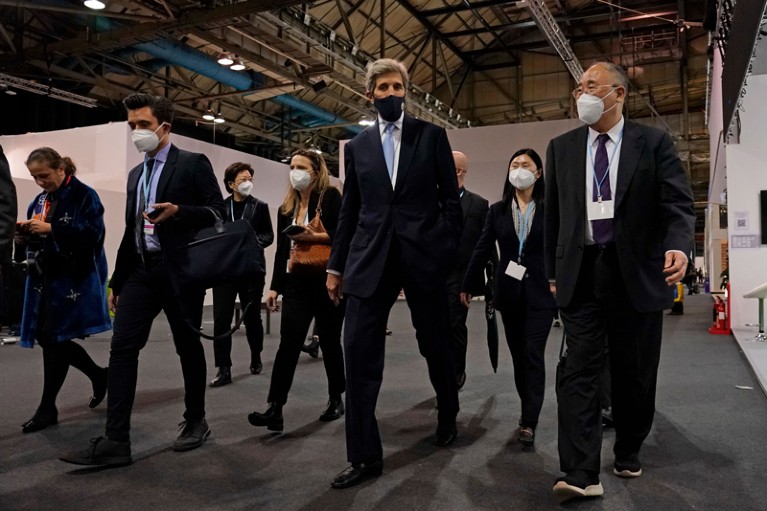 Xie Zhenhua walks with John Kerry whilst wearing face masks at the Climate COP26 Summit