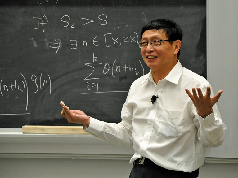 Yitang Zhang at the blackboard during the documentary film ‘Counting from Infinity’ in 2015.