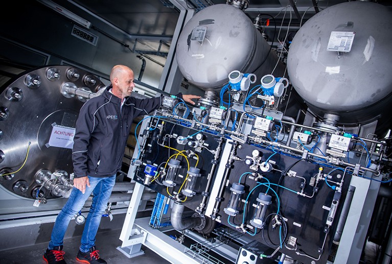 Apex Energy plant manager Guido Knig testing the electrolysis plant in their hydrogen power plant.