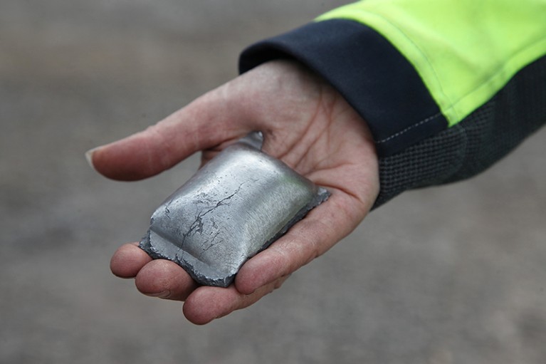 A Hybrit initiative employee shows fossil-free produced sponge iron, the raw material from which steel is made.