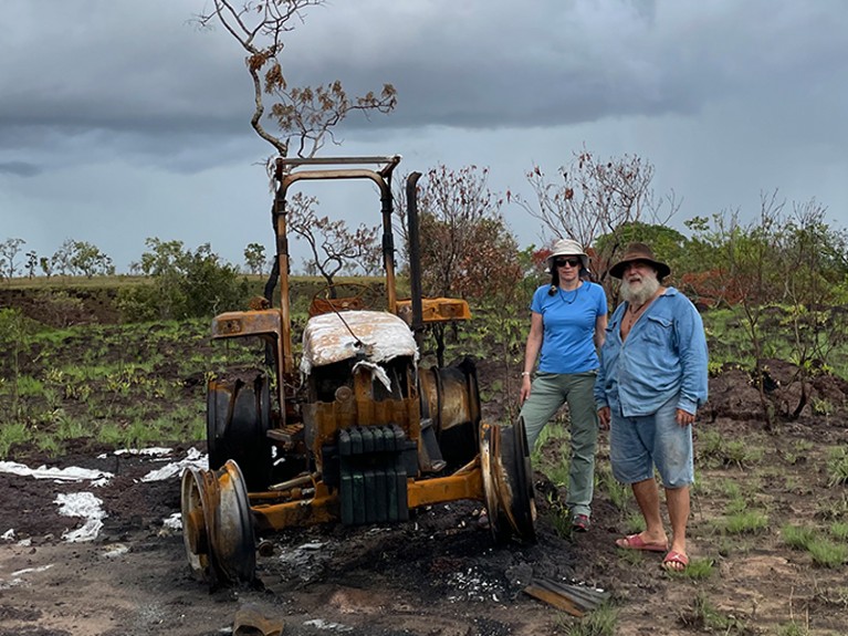 Dolors with Herrara near his burnt tractor in a private reserve in the Colombian Orinoco basin.