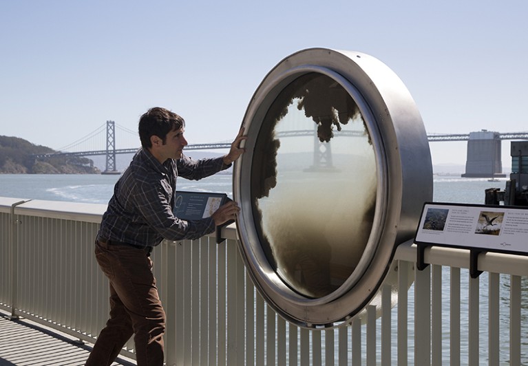 A visitor interacts with the "Bay Windows" exhibit at the Exploratorium in San Francisco, at its new location at the Piers.