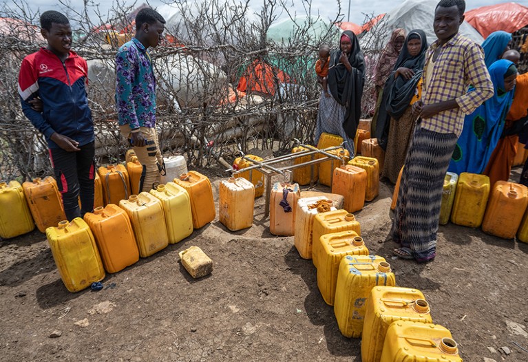 Somalis displaced by drought and war wait for water at the Sebedow Camp.