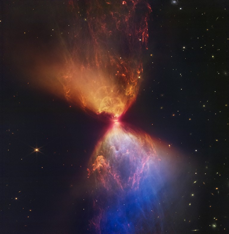 The hourglass-shaped protostar within the dark cloud L1527 is embedded within a cloud of material feeding its growth.