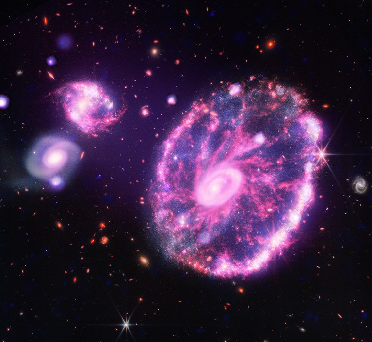 The Cartwheel galaxy gets its round, spin shape from a collision with another smaller galaxy about 100 million years ago.