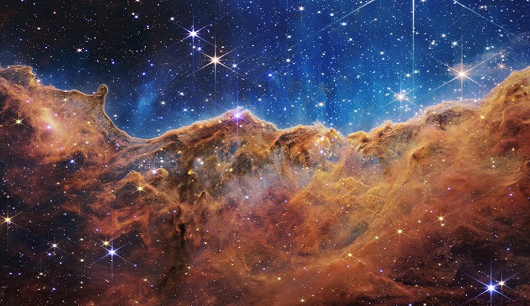 A nearby, young, star-forming region called NGC 3324 in the Carina Nebula, with stars behind a "mountainous" looking form.
