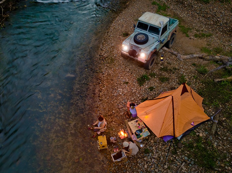 People camp near the river.