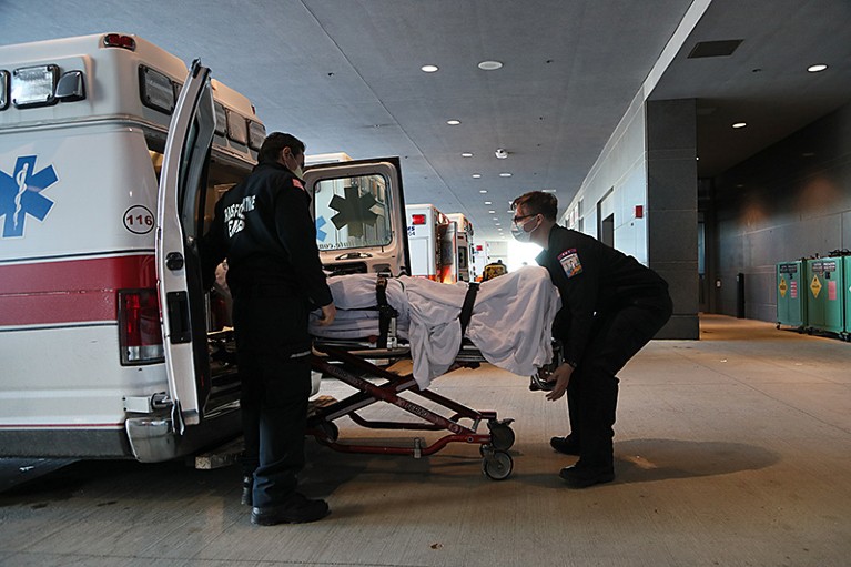 EMTs transfer a patient in the ambulance bay at UMass Memorial Medical Center in Worcester, Massachusetts, U.S.