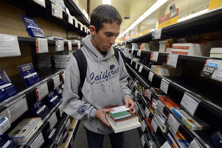A biology student browses for textbooks at the university bookshop.