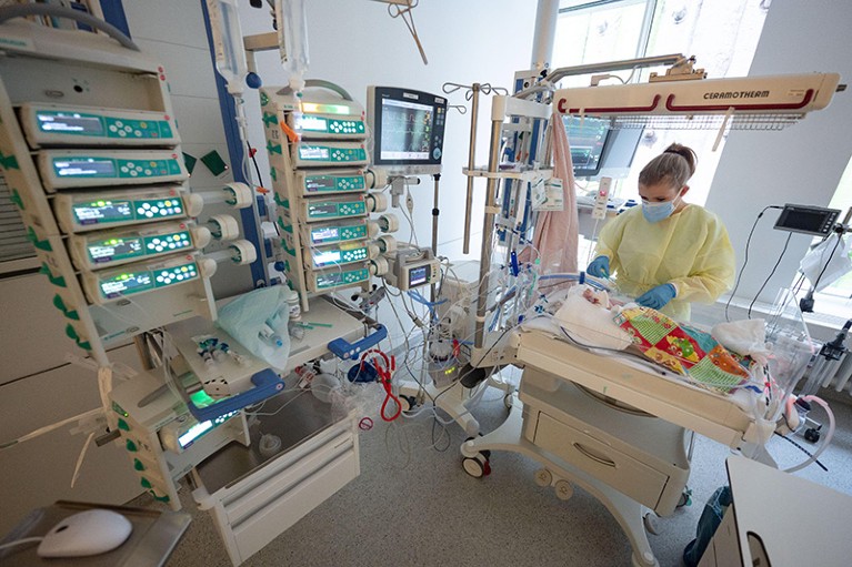 An intensive care nurse treats a ventilated patient with respiratory syncytial virus (RSV) in the children's intensive care unit
