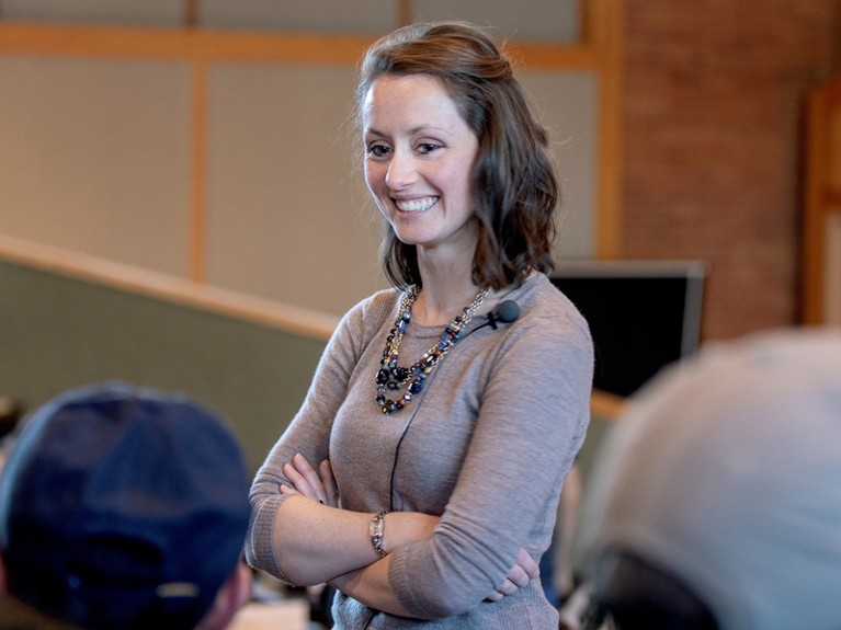 Natasha Holmes observing students during an interactive physics lecture.