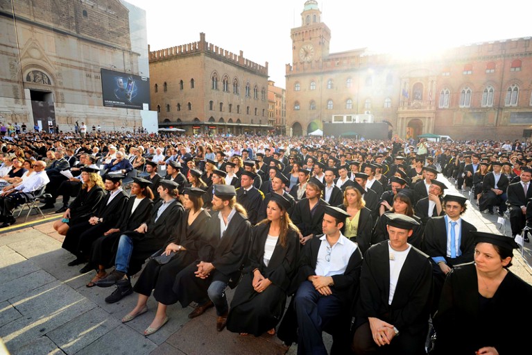 Scholars of the University of Bologna attend their PhD ceremony at golden hour