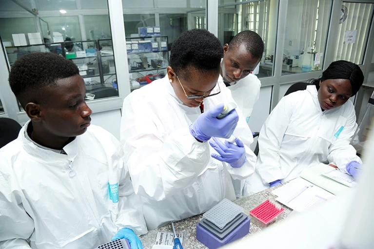 Scientists at the African Centre of Excellence for Genomics of Infectious Diseases in Ede, Nigeria, prepare samples for DNA sequencing.Credit: ACEGID