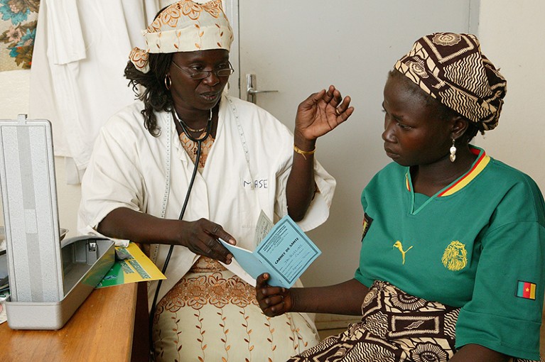 A female doctor is examining a woman during prenatal testing in Garoua, Cameroon, Africa.