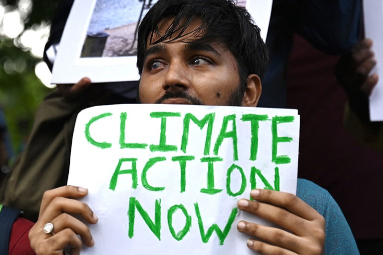 A man holds a placard with the words 'Climate Action Now', at a demonstration in support of environmental protection in Mumbai