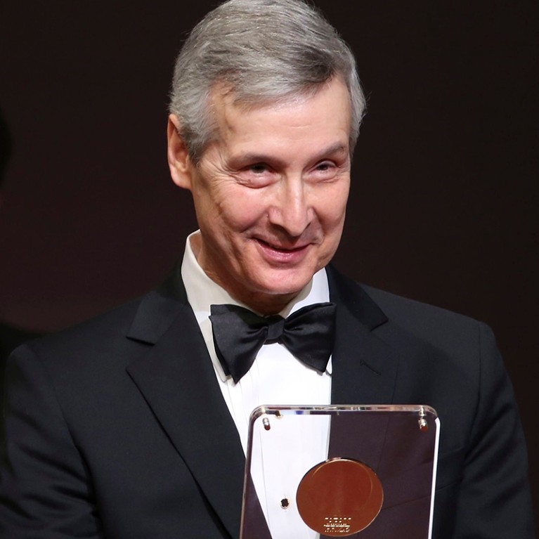 Molecular biologist Charles David Allis of the U.S. holds the Japan Prize award during the presentation ceremony in Tokyo, Japan