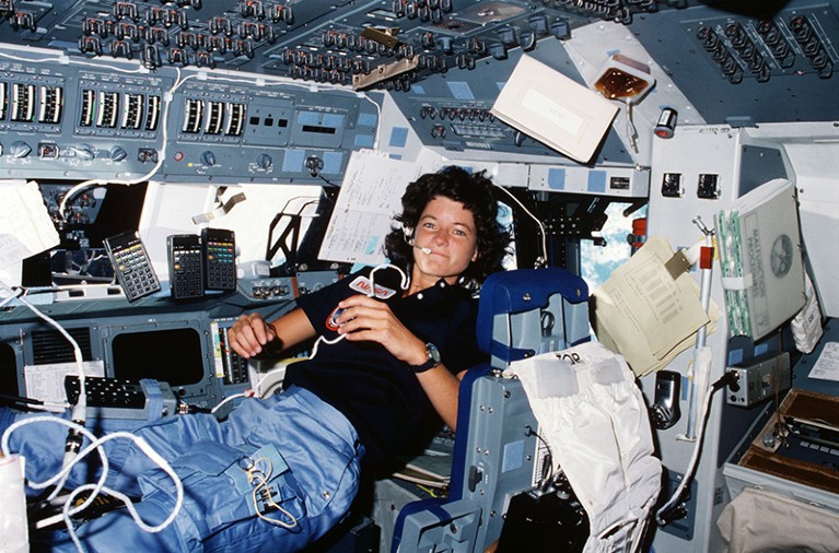 Astronaut Sally Ride multitasks during space travel.