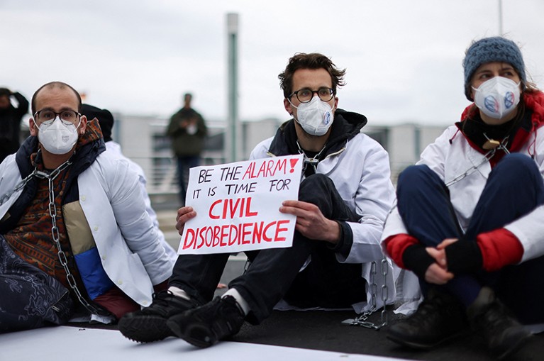 Activists from the Scientist Rebellion climate change group block a bridge in central Berlin.