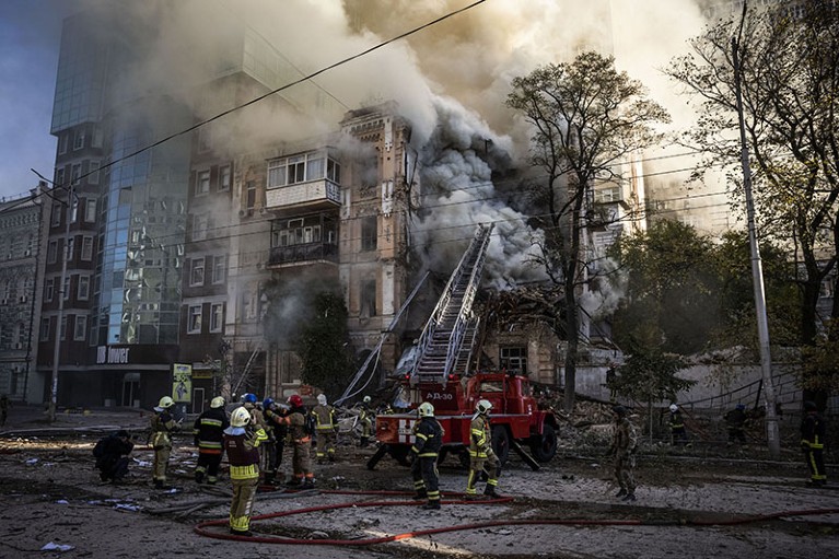 An Iranian-made Shahed-136 drone targets and hits a building in Kyiv, Ukraine, where emergency responders work at the scene.