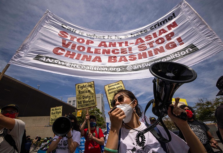 An Asian woman protests anti-Asian violence during a march.