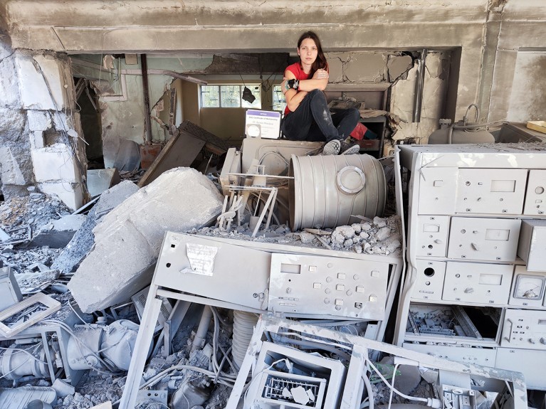 Kseniia Minakova in the rubble of her destroyed lab, KhPI Kharkiv Ukraine Optic Science Lab, on August 25, 2022.