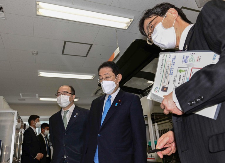 Japanese Prime Minister Fumio Kishida gets a firsthand look at a research facility at Kobe University