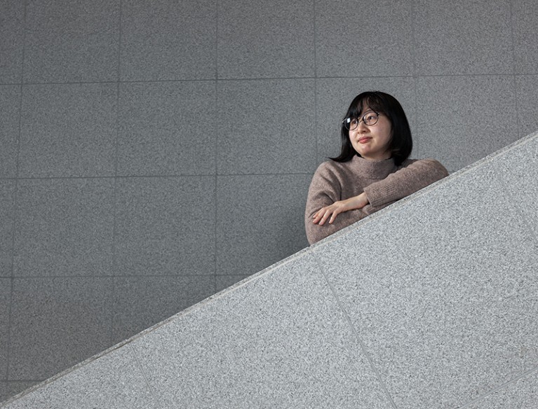 Mariko Kimura standing on a staircase with arms folded