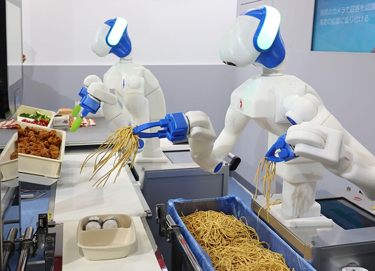 Humanoid robots pick fried chicken and noodles to assemble lunch boxes