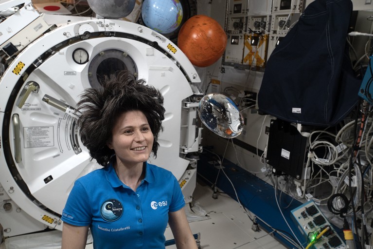 Astronaut Samantha Cristoforetti observes the behavior of a free-flying water bubble inside the International Space Station.
