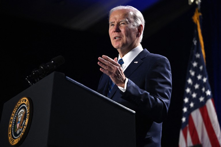 Close-up of US President Joe Biden gesturing as he speaks during a conference