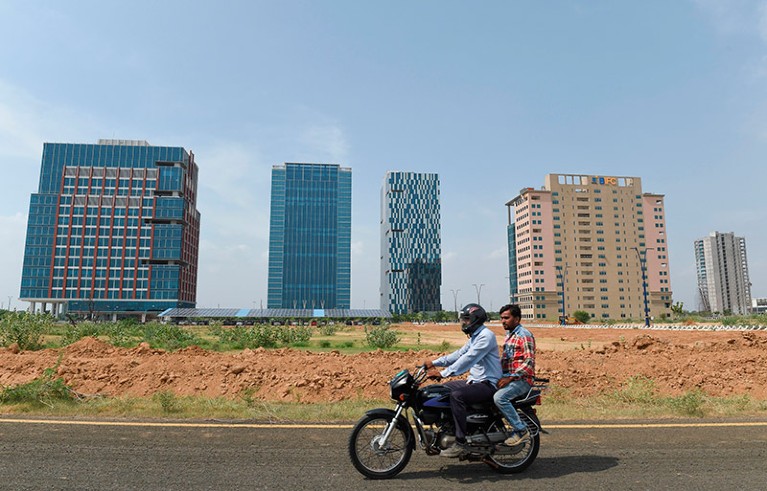 Men ride a motorbike at Gujarat International Finance Tec-city (GIFT) in Gandhinagar.