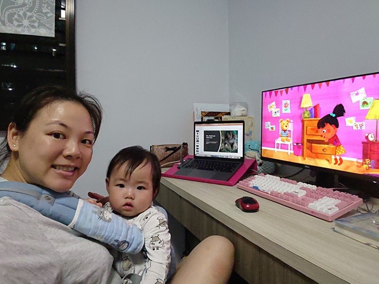 Working from home during COVID 2020, Mei Lin Neo with her kid.